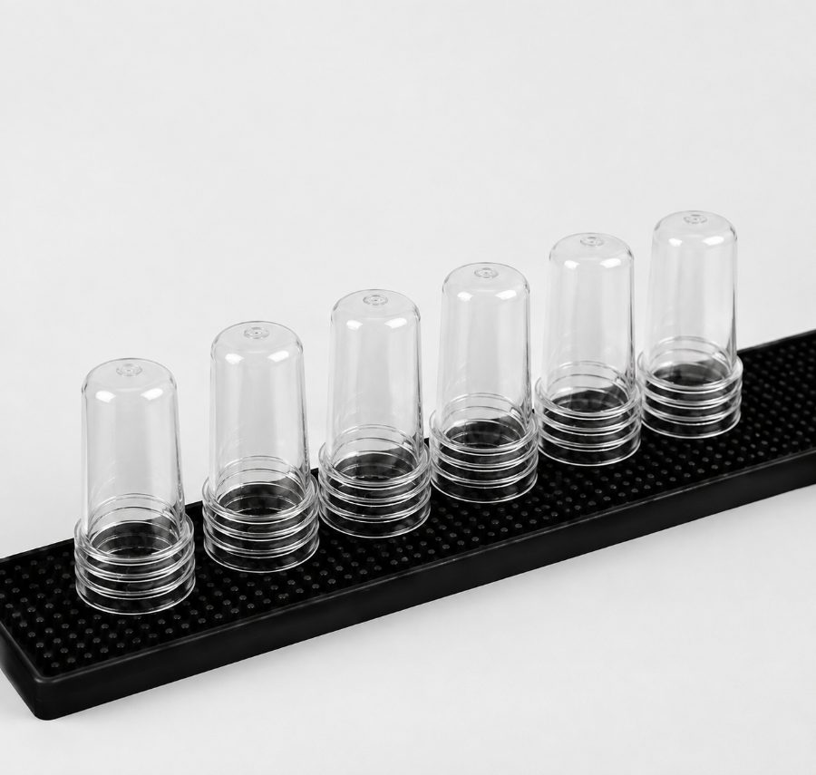 Six Bar Armour caps lined up on a bar mat